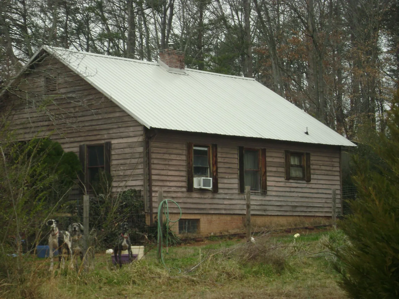 White metal roof on an old wood sided farmhouse, from a Metal Roof Installation job in Plumerville